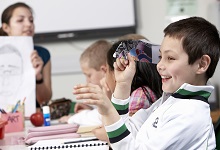 boy with paper aeroplane in class